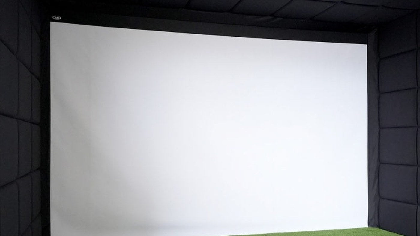 Indoor golf impact screen with dark padded walls and ceiling for screen-fill planning.
