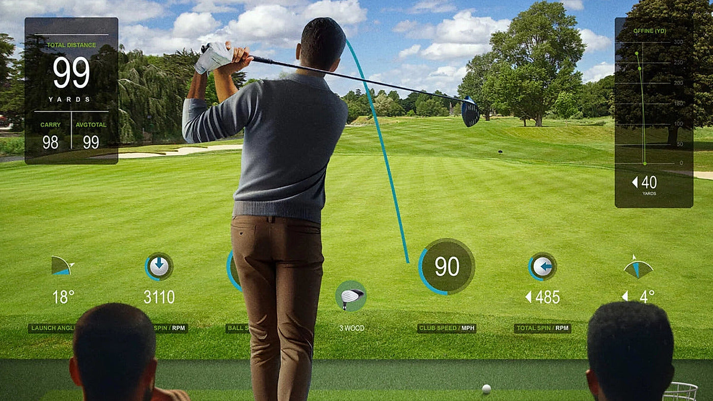 BenQ AK700ST in an indoor golf simulator setting for the AK700ST versus LK830ST comparison.