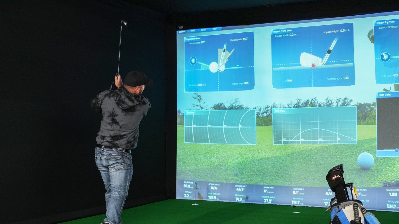 Carl's Place golf simulator enclosure in an indoor golf setup.