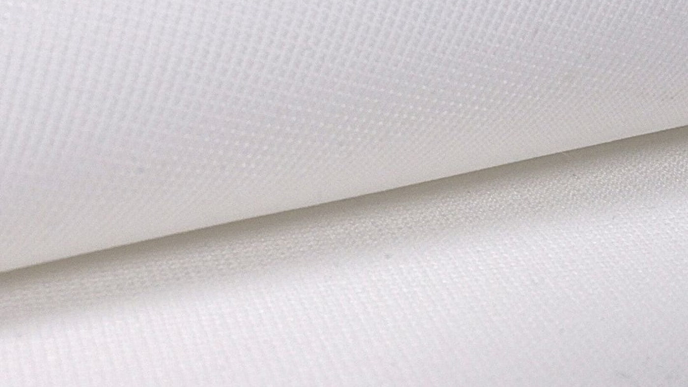 Folded SIGPRO Premium impact-screen fabric showing the woven surface and finished thickness.