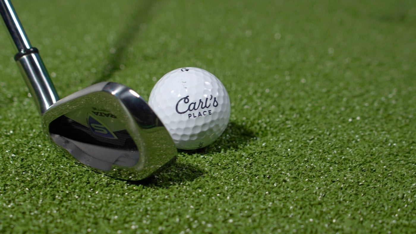 Golf iron and Carl’s Place ball on a HotShot hitting surface.