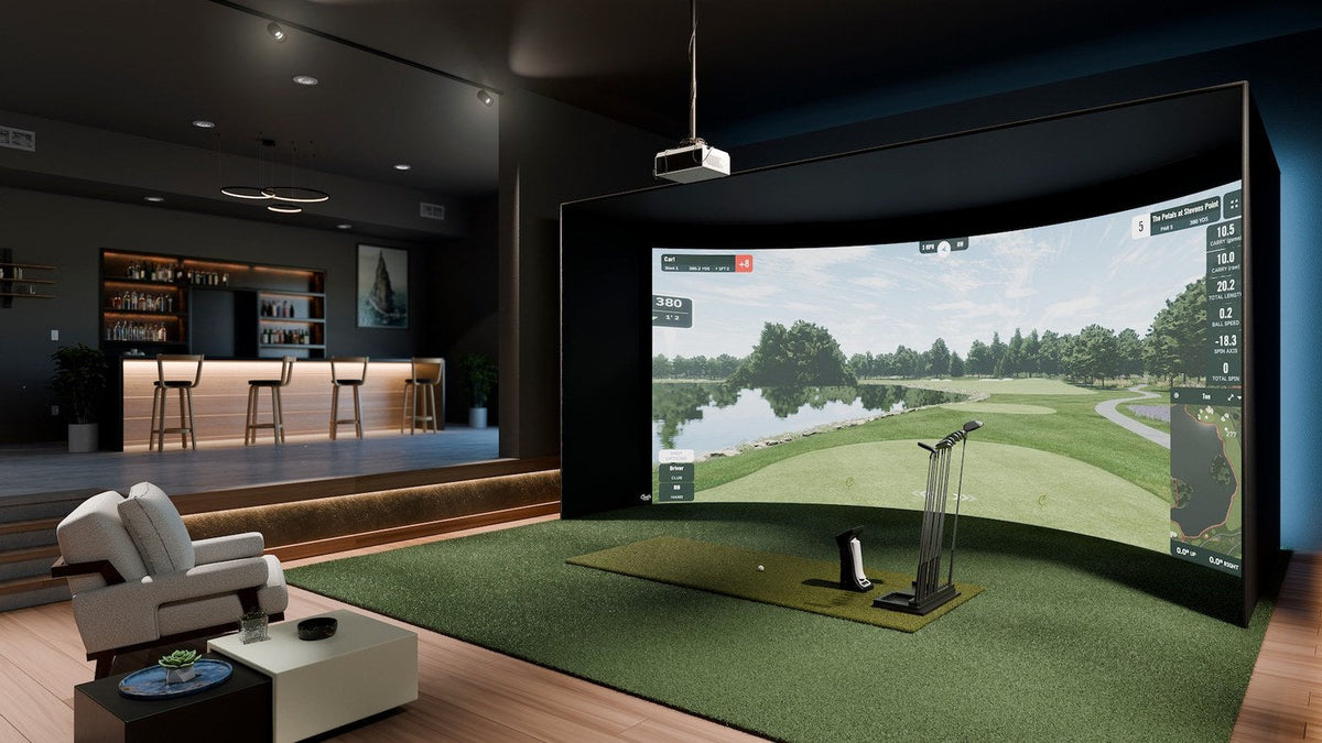 Carl's Place curved impact screen in a finished indoor golf room.