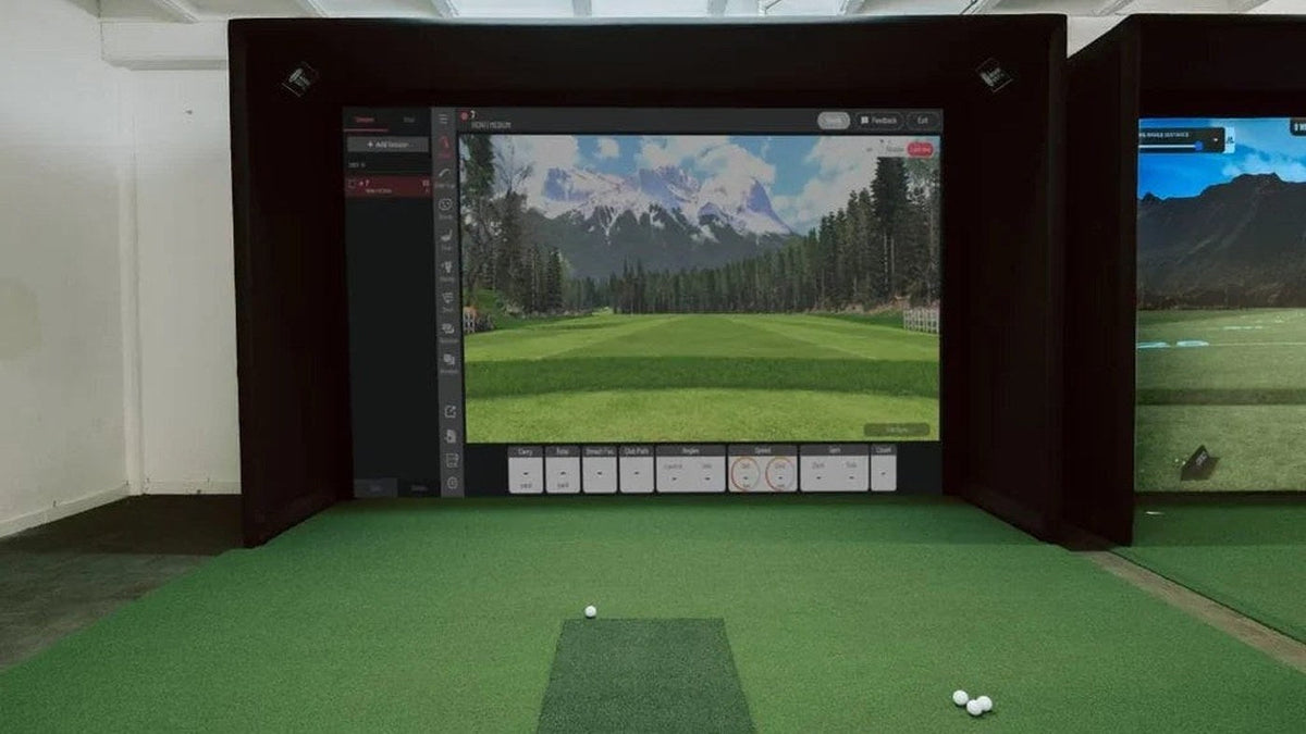 Indoor simulator bay with a projected golf course