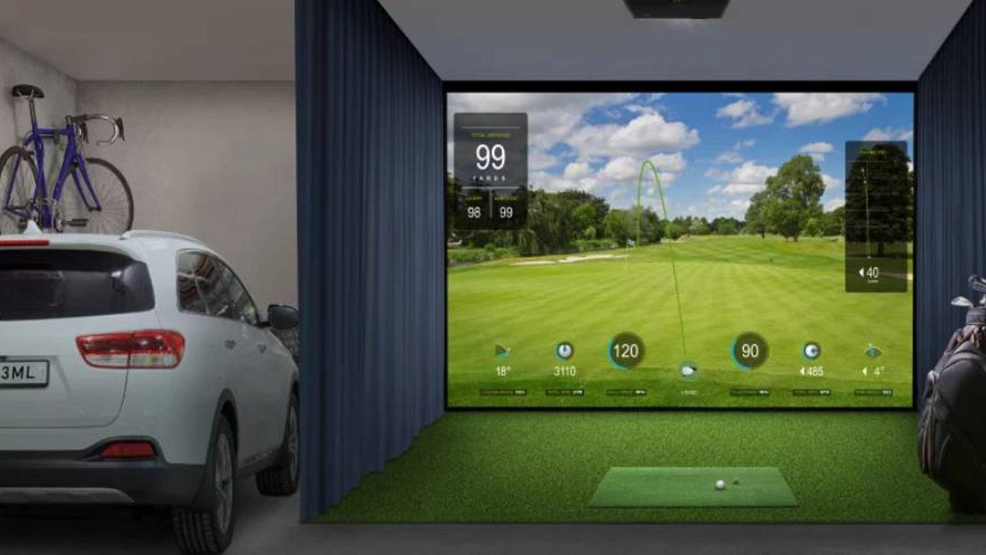 Garage golf simulator with a ceiling-mounted projector, impact screen and hitting mat