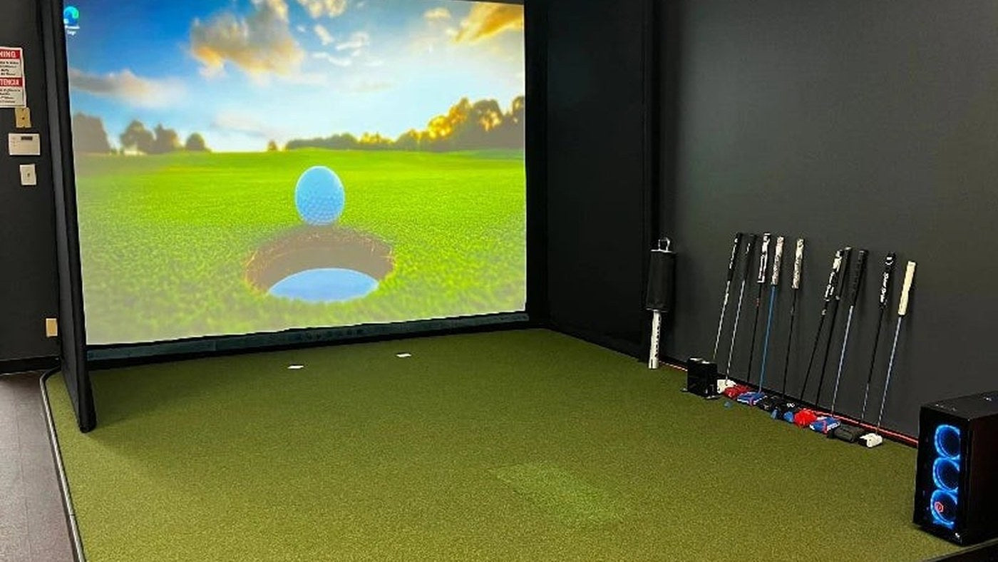 Finished simulator room with a hitting mat and continuous floor