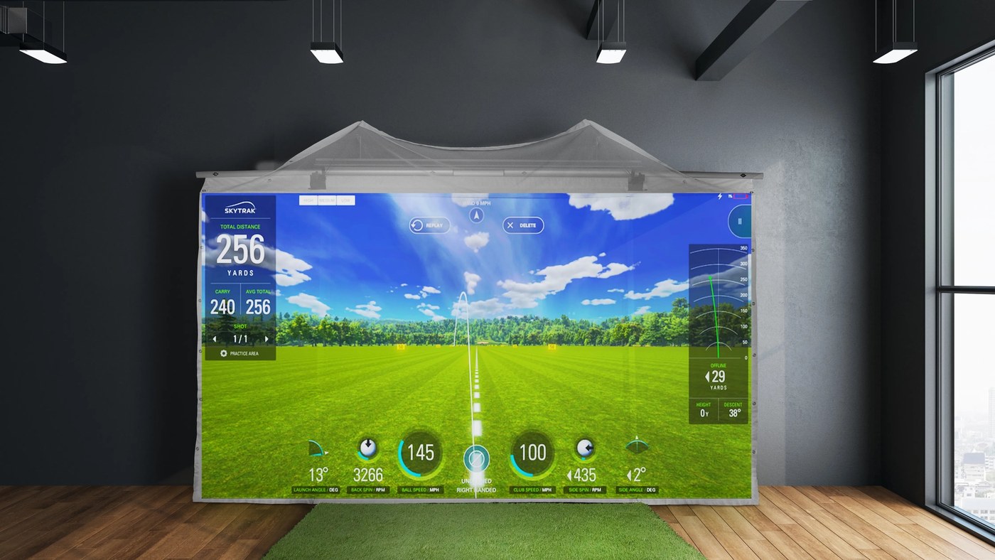 HomeCourse retractable screen deployed in an indoor golf room