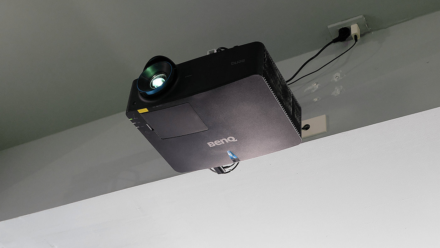 BenQ LU935ST installed in a golf simulator for the LU935ST versus LK936ST comparison.