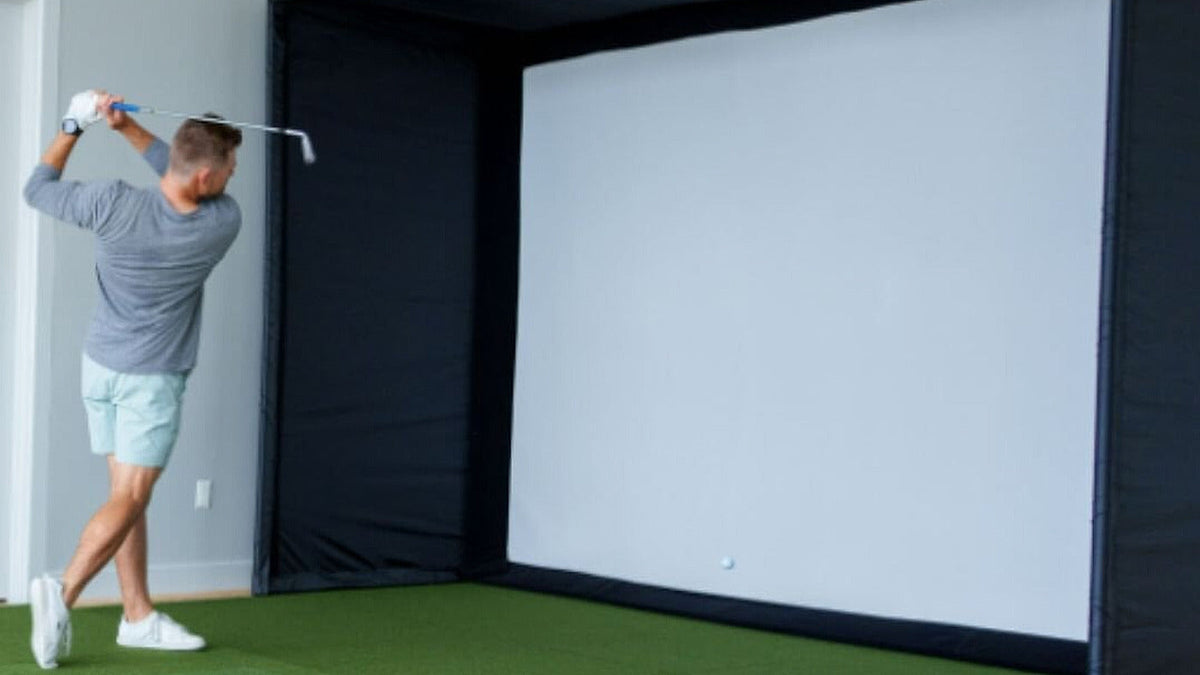 SIG10 golf simulator enclosure with golfer for the SIG10 versus SIG12 enclosure comparison.