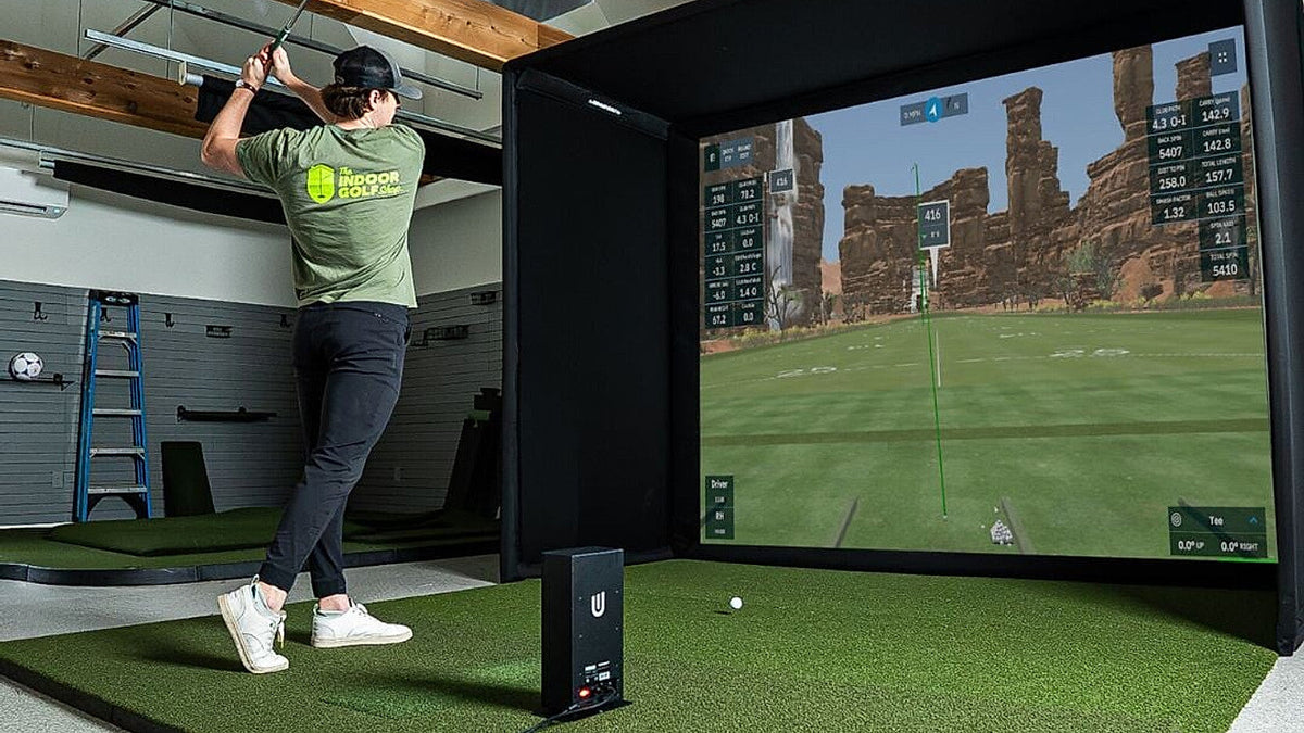 Uneekor EYE MINI LITE in an indoor golf simulator, illustrating the EYE MINI versus EYE MINI LITE comparison.