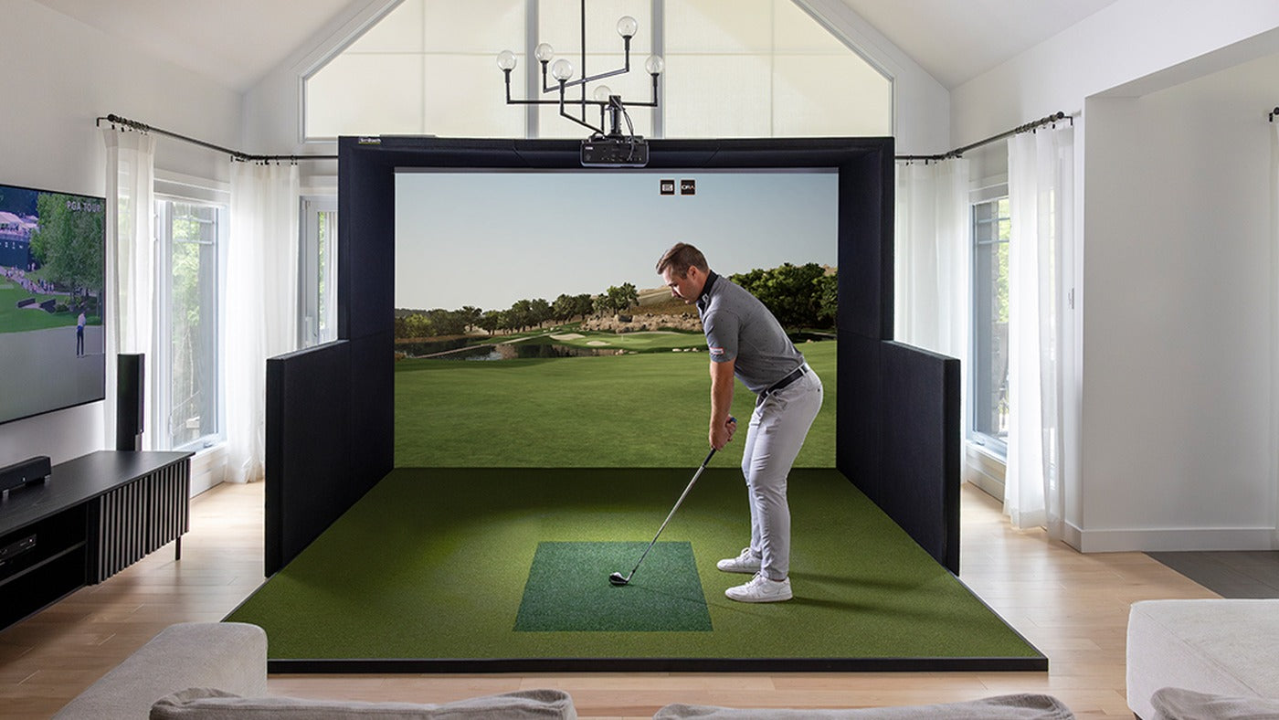 Indoor golf simulator room showing the screen and hitting area for room-planning context