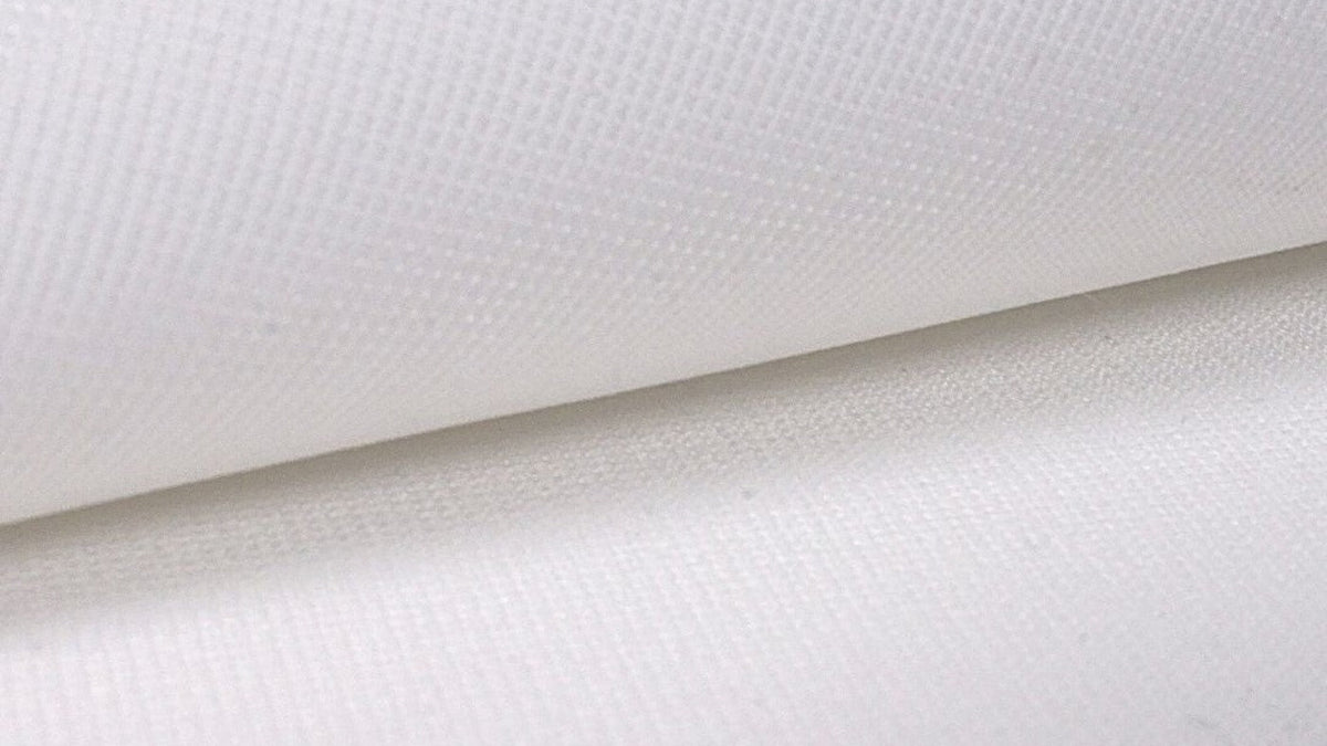 Folded SIGPRO Premium impact-screen fabric showing the woven surface and finished thickness.