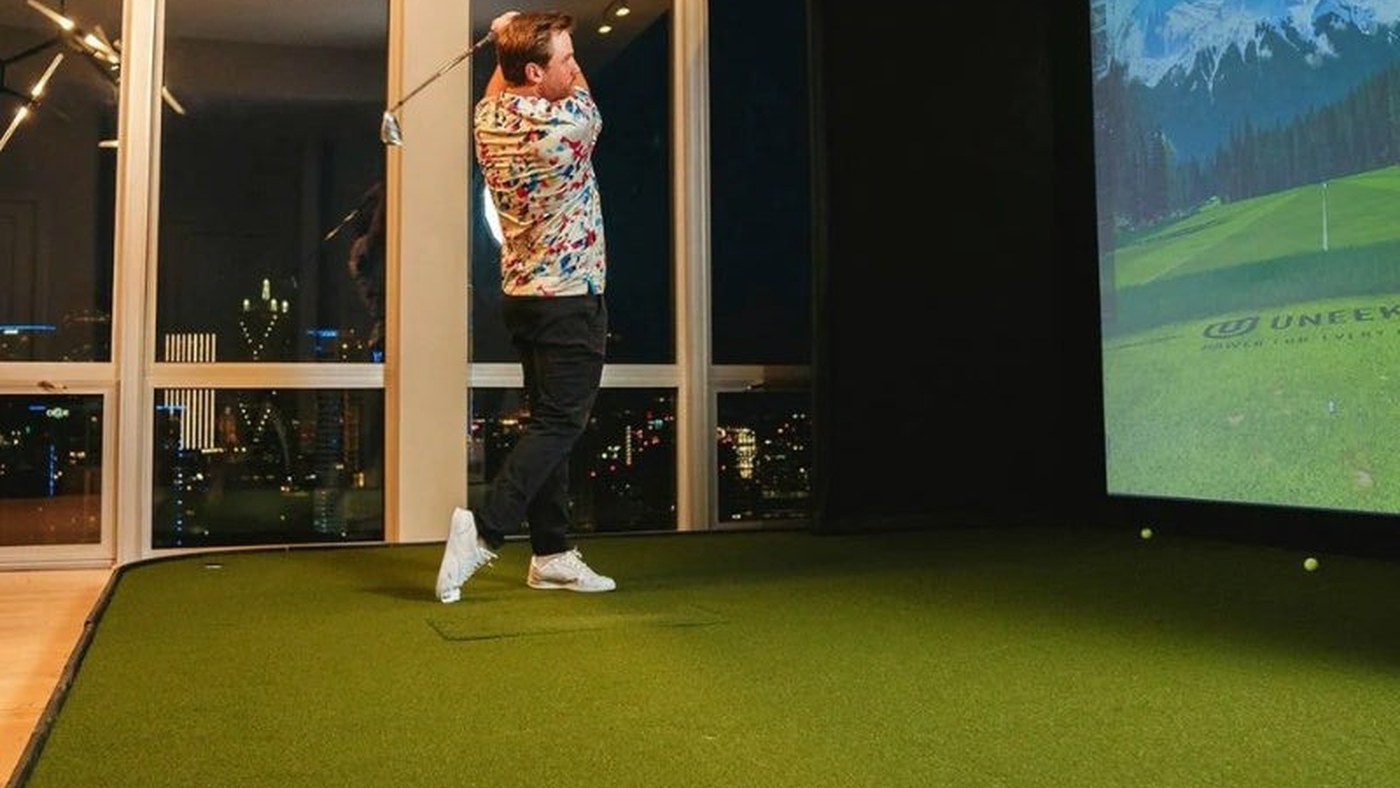 SIGPRO simulator flooring extending from the screen to the hitting area